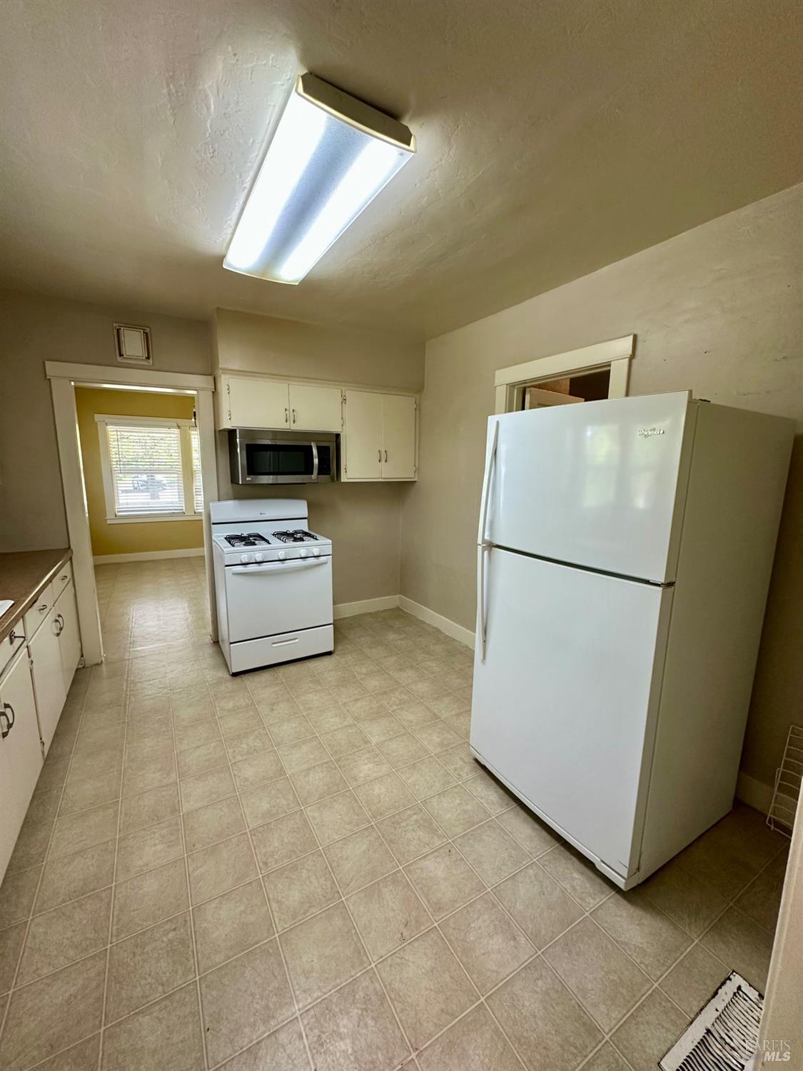994 Sanitarium Road Deer Park, CA 94576 - Photo 10 of 21 a kitchen with cabinets and refrigerator