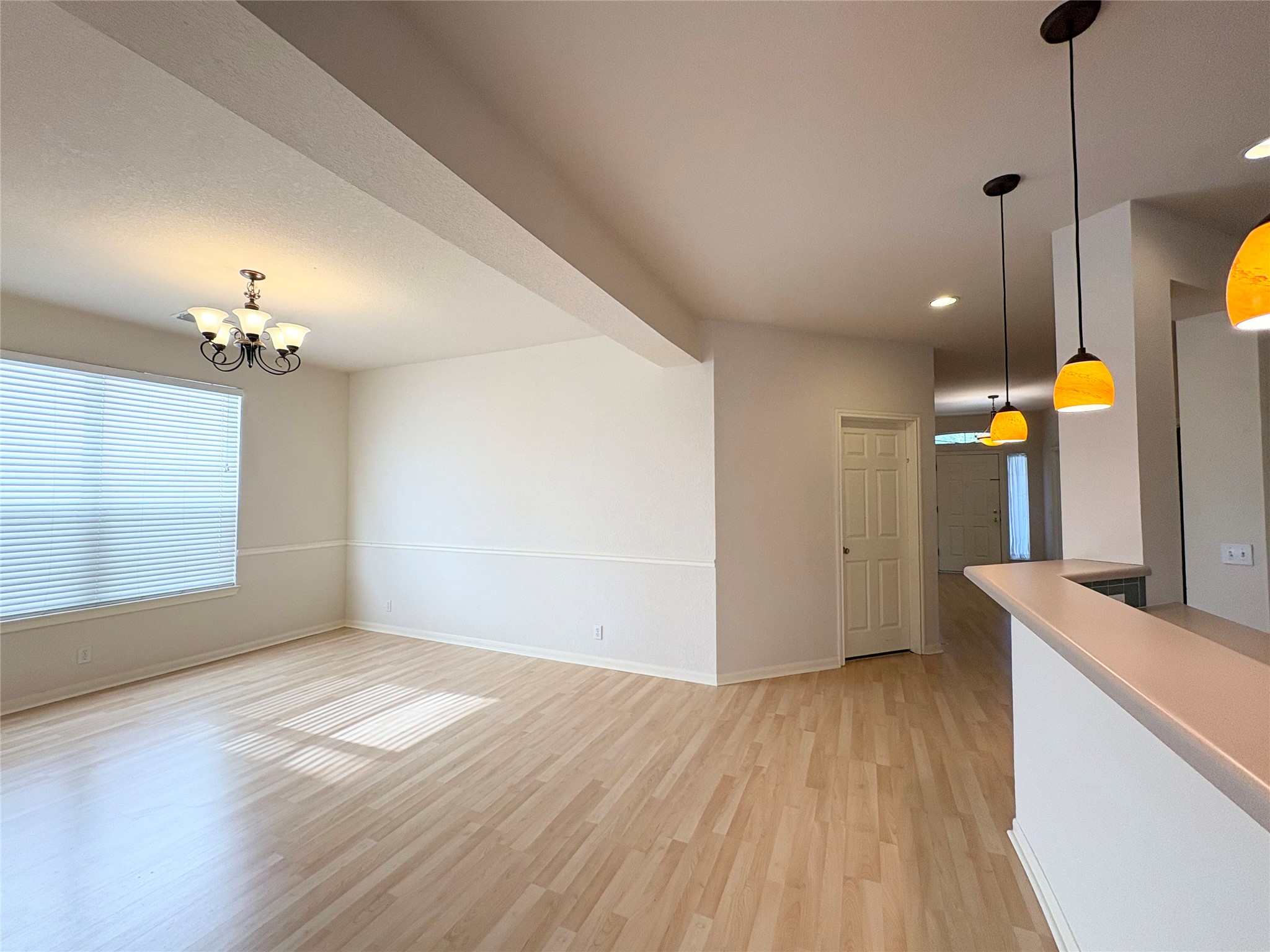 7006 Rambollet Terrace Round Rock, TX 78681 - Photo 8 of 38 Blonde wood flooring creates a seamless flow throughout this bright, open-concept living area.
