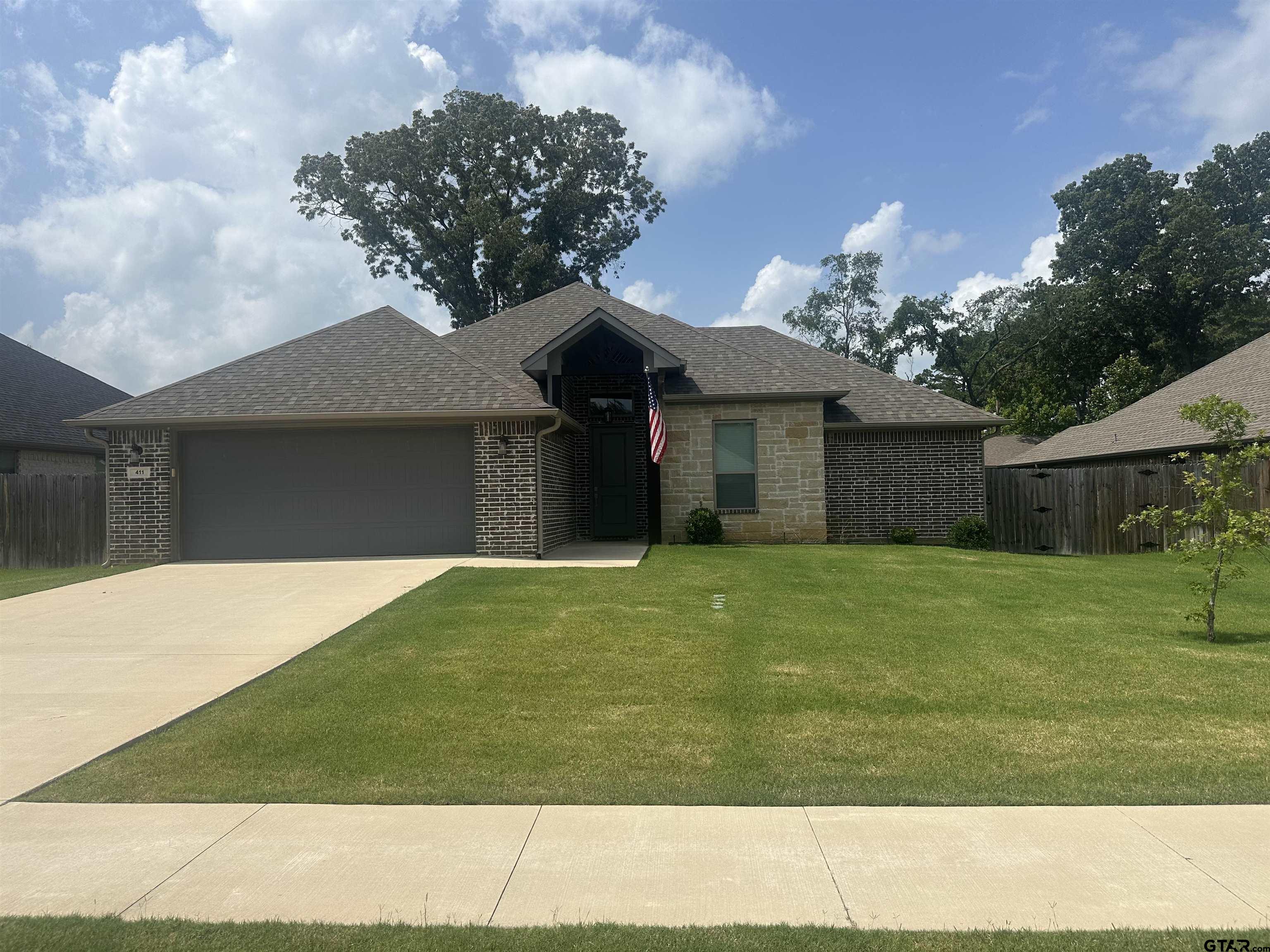411 Deer Point Cove Chandler, TX 75758 - Photo 1 of 21 a front view of a house with a garden
