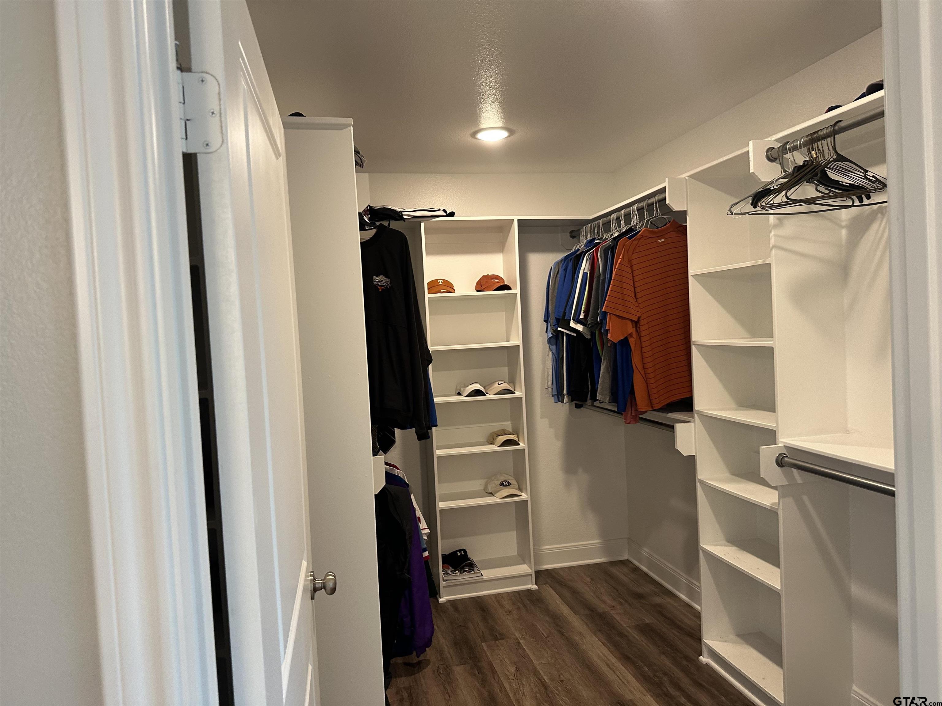 411 Deer Point Cove Chandler, TX 75758 - Photo 12 of 21 a view of walk in closet with clothes and shoes