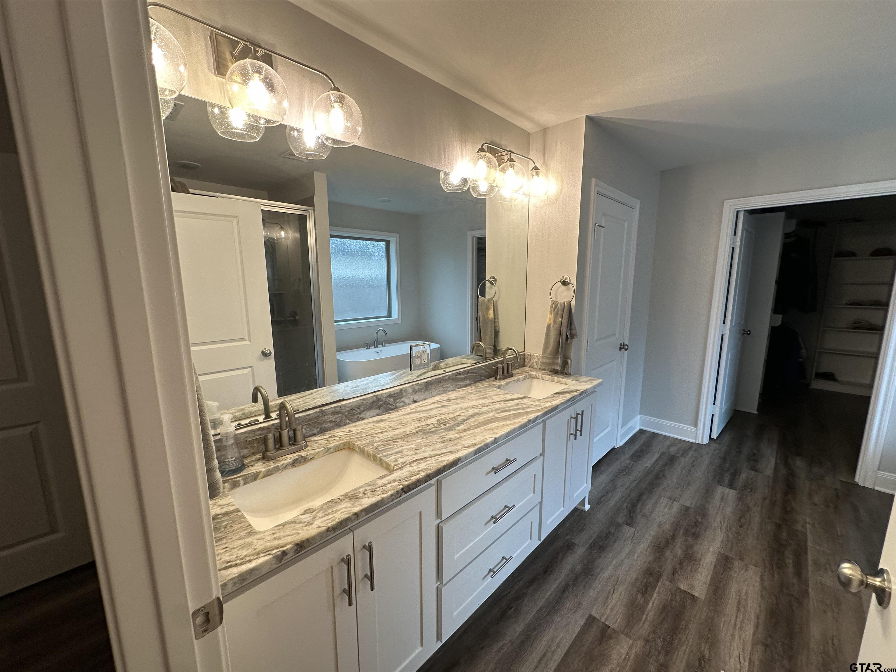 411 Deer Point Cove Chandler, TX 75758 - Photo 15 of 21 a bathroom with a double vanity sink and a mirror