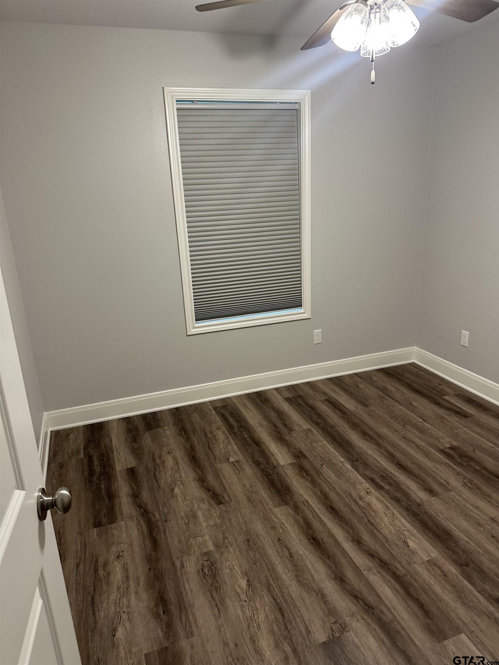 411 Deer Point Cove Chandler, TX 75758 - Photo 16 of 21 a view of a room with wooden floor and a window