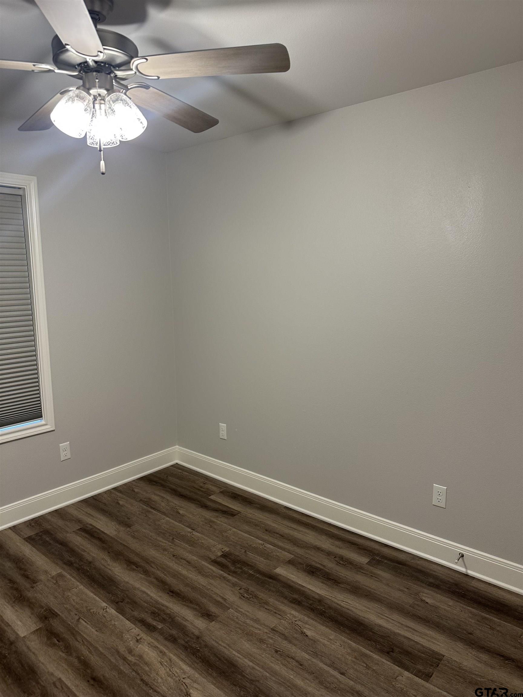 411 Deer Point Cove Chandler, TX 75758 - Photo 17 of 21 a view of a room with wooden floor and chandelier fan