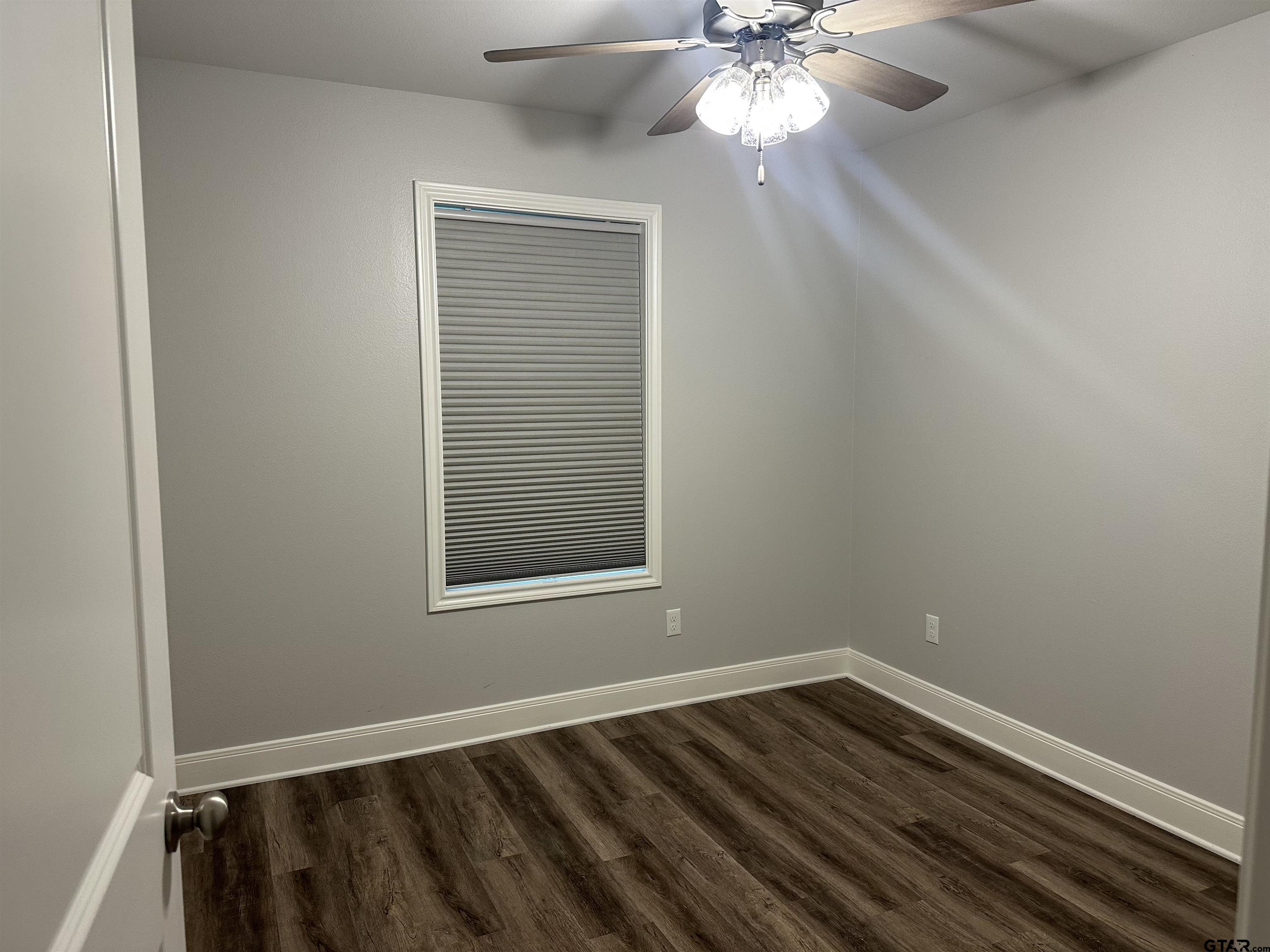 411 Deer Point Cove Chandler, TX 75758 - Photo 18 of 21 an empty room with a window and wooden floor