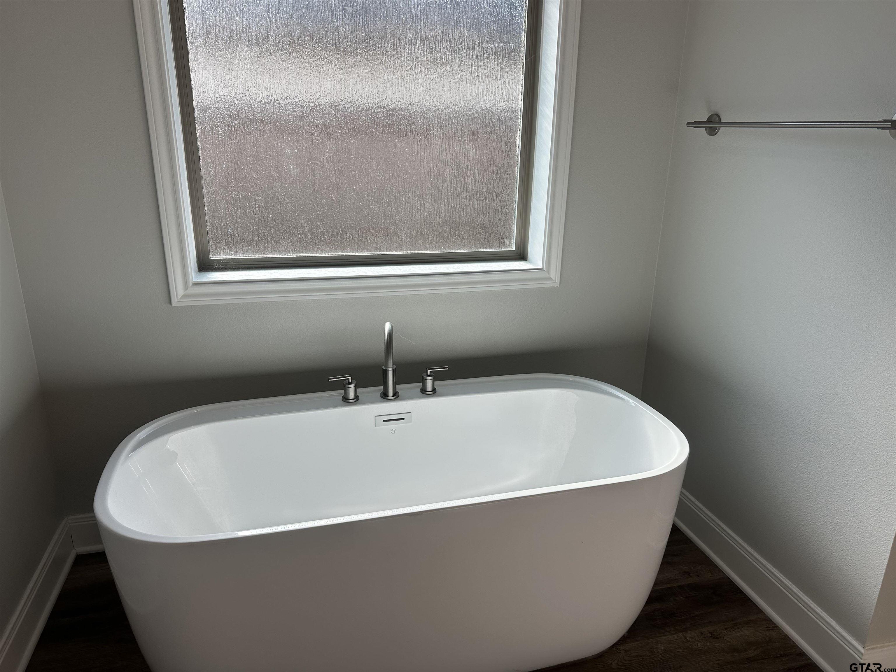 411 Deer Point Cove Chandler, TX 75758 - Photo 19 of 21 a white tub sitting next to a small window