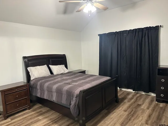 a bedroom with a bed and a dresser