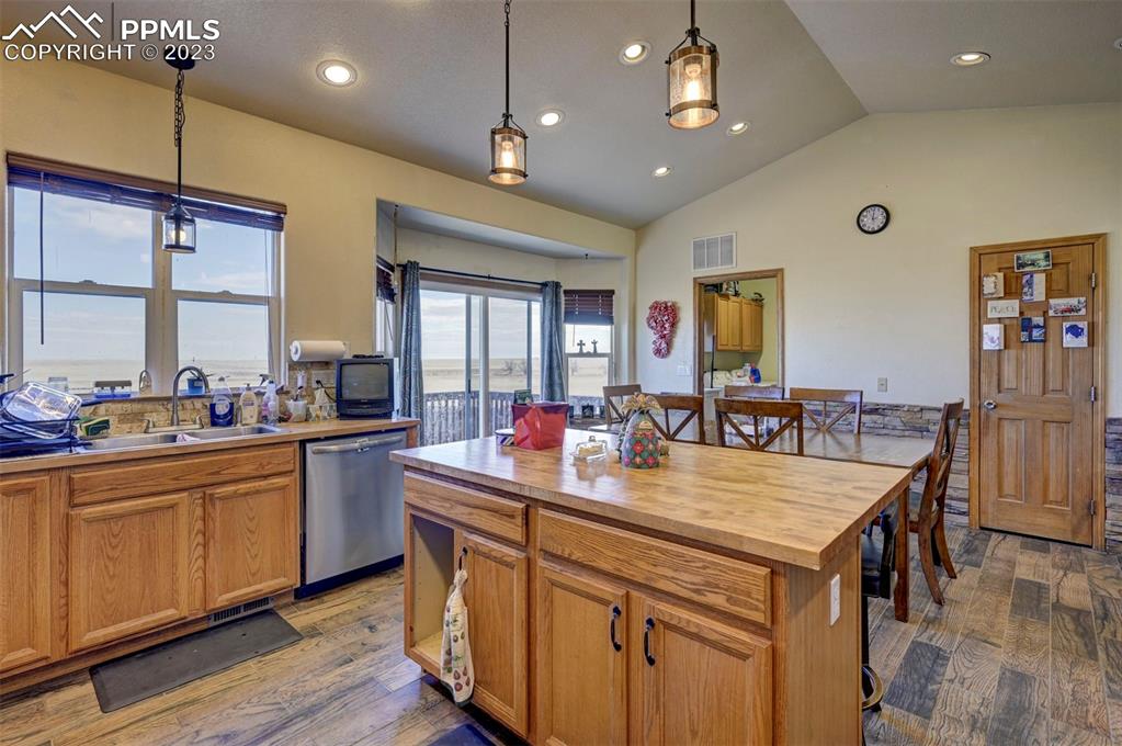 31790 Sanborn Road Yoder, CO 80864 - Photo 11 of 50 a kitchen with stainless steel appliances granite countertop a stove a sink dishwasher and a refrigerator with white cabinets
