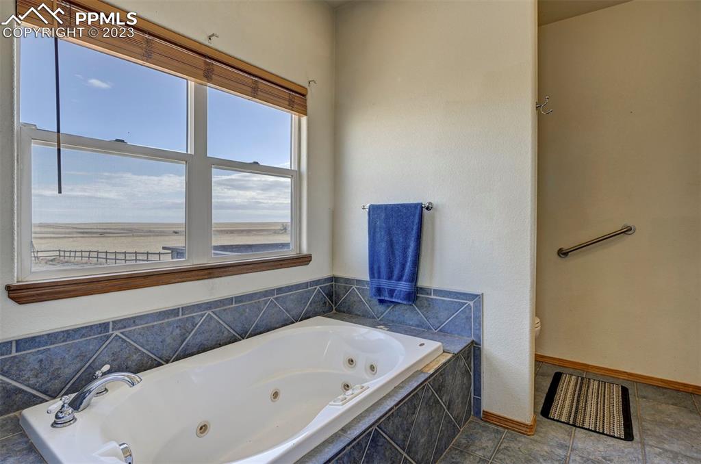 31790 Sanborn Road Yoder, CO 80864 - Photo 17 of 50 a bathroom with a tub and a sink