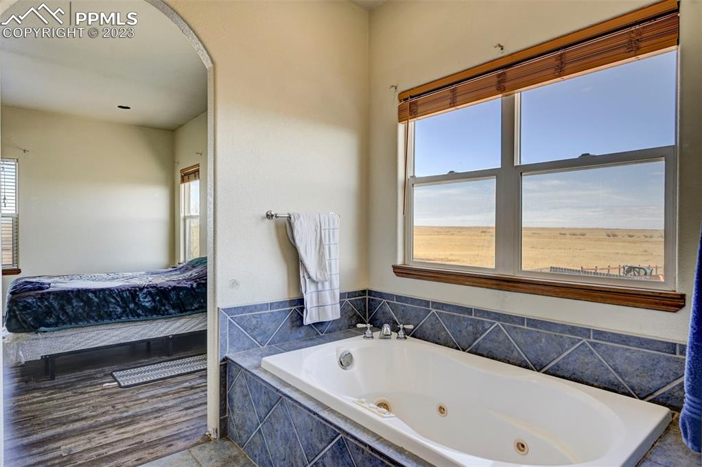 31790 Sanborn Road Yoder, CO 80864 - Photo 20 of 50 a bathroom with a bathtub and a window