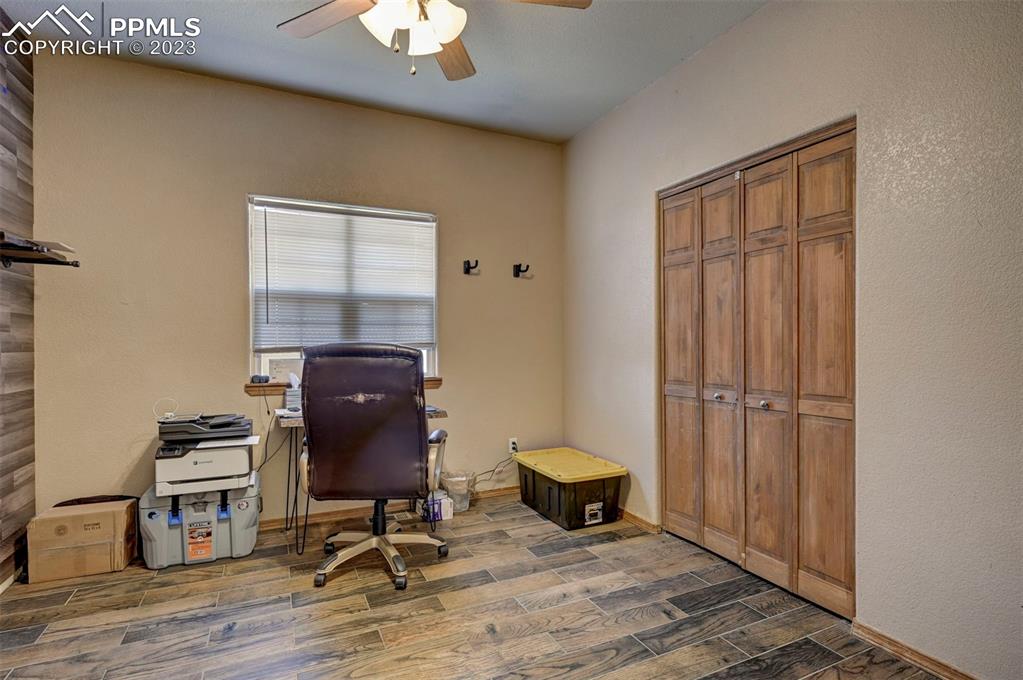 31790 Sanborn Road Yoder, CO 80864 - Photo 24 of 50 a view of workspace with wooden floor cabinet and windows