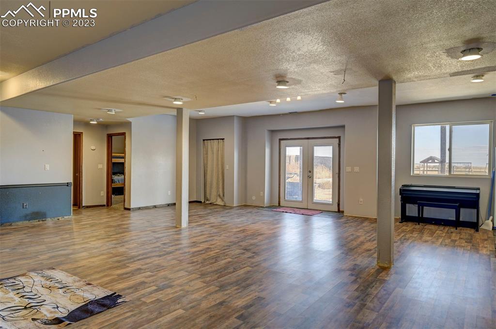 31790 Sanborn Road Yoder, CO 80864 - Photo 34 of 50 a view of an empty room with wooden floor and a window
