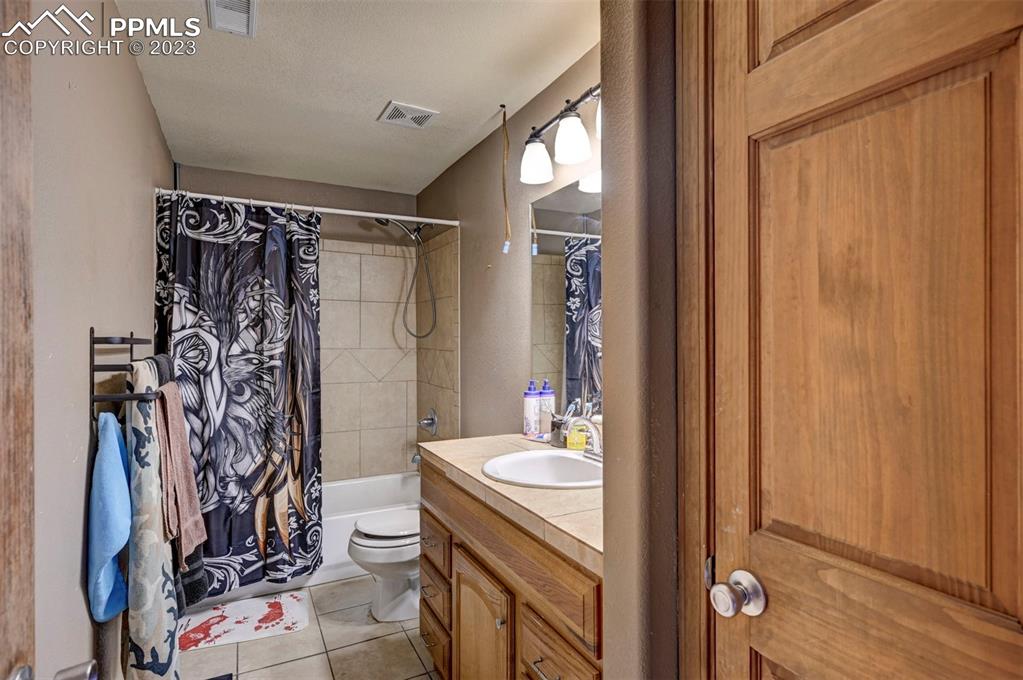 31790 Sanborn Road Yoder, CO 80864 - Photo 37 of 50 a bathroom with a sink a toilet and shower