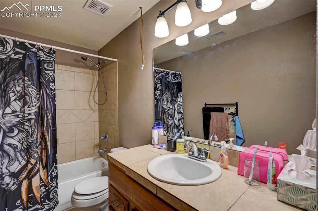 31790 Sanborn Road Yoder, CO 80864 - Photo 38 of 50 a bathroom with a sink a toilet and shower