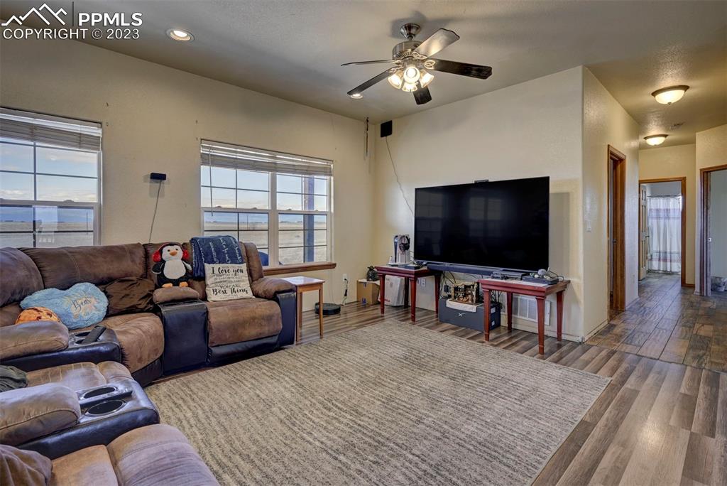 31790 Sanborn Road Yoder, CO 80864 - Photo 5 of 50 a living room with furniture and a flat screen tv