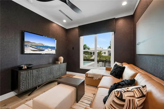 a bedroom with a bed a table and painting on the wall