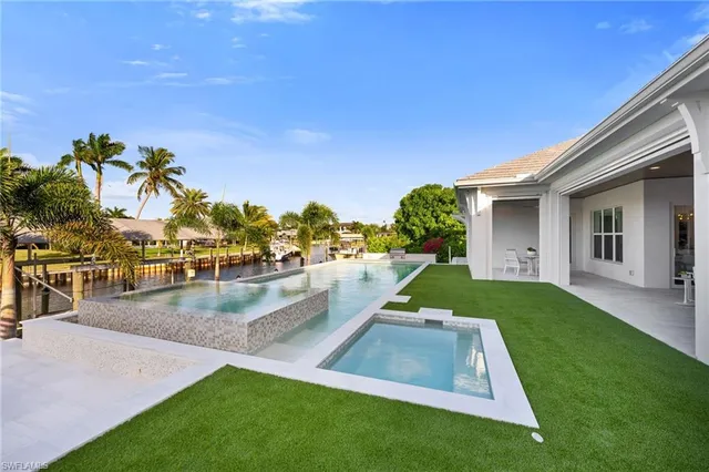 a view of a backyard with swimming pool