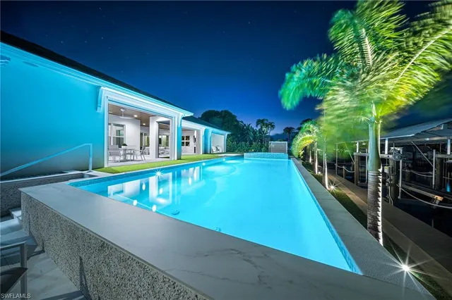 an aerial view of residential houses with outdoor space and lake view