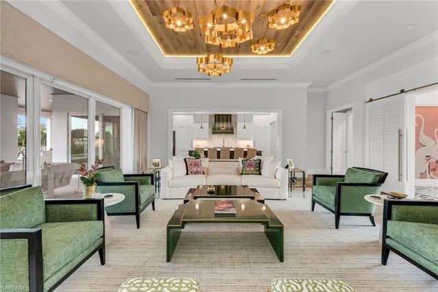 a living room with furniture and a chandelier