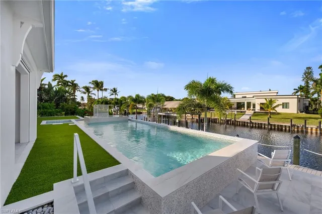a view of swimming pool with outdoor seating and a patio
