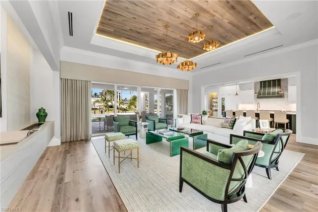 a kitchen with stainless steel appliances kitchen island granite countertop a table chairs sink and cabinets