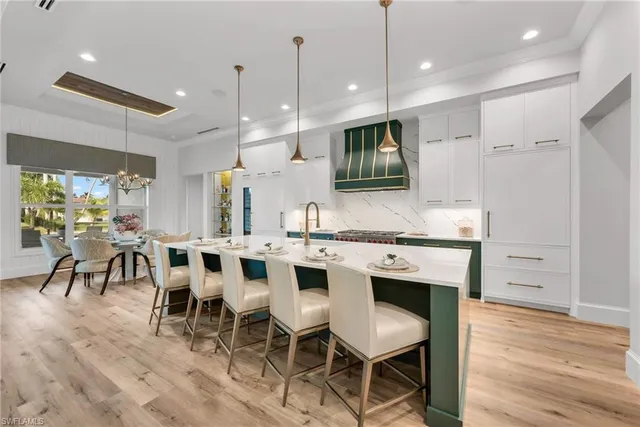 a kitchen with kitchen island a sink stove and refrigerator