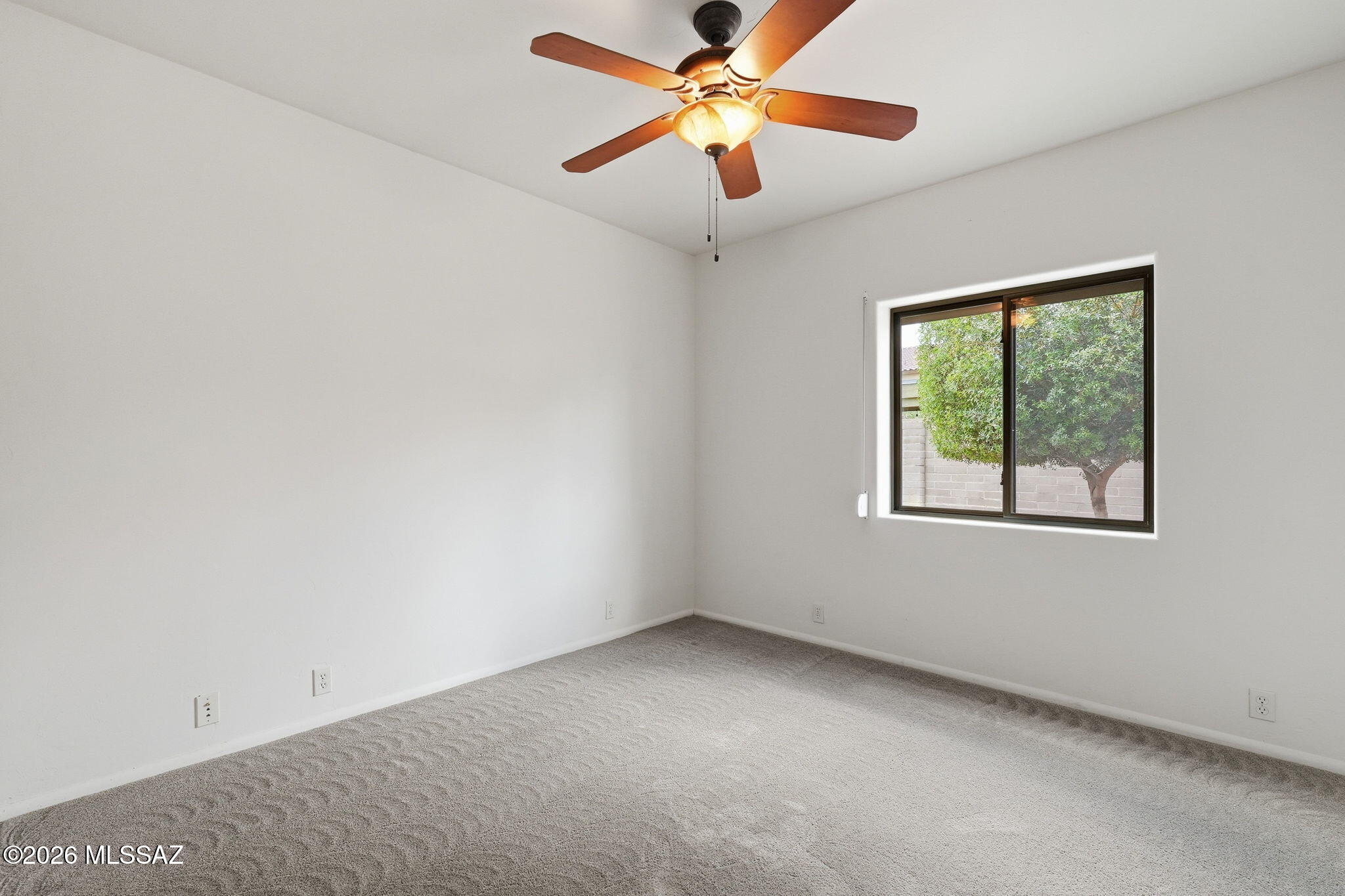 1125 East Kleindale Road Tucson, AZ 85719 - Photo 39 of 49 an empty room with a window and a fan