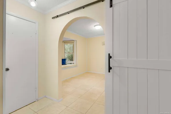 a view of a hallway with wooden floor and entryway