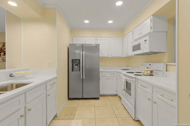a kitchen with cabinets and stainless steel appliances