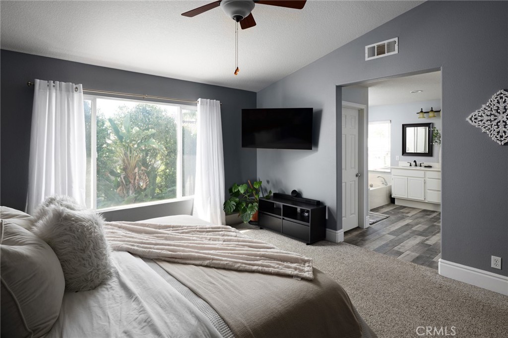 32 Berlamo Rancho Santa Margarita, CA 92688 - Photo 14 of 59 a bedroom with a bed a television and wooden floor