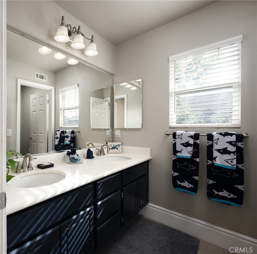 32 Berlamo Rancho Santa Margarita, CA 92688 - Photo 21 of 59 a bathroom with a double vanity sink and a mirror