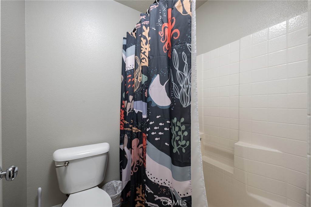 32 Berlamo Rancho Santa Margarita, CA 92688 - Photo 22 of 59 a bathroom with a toilet and shower curtain