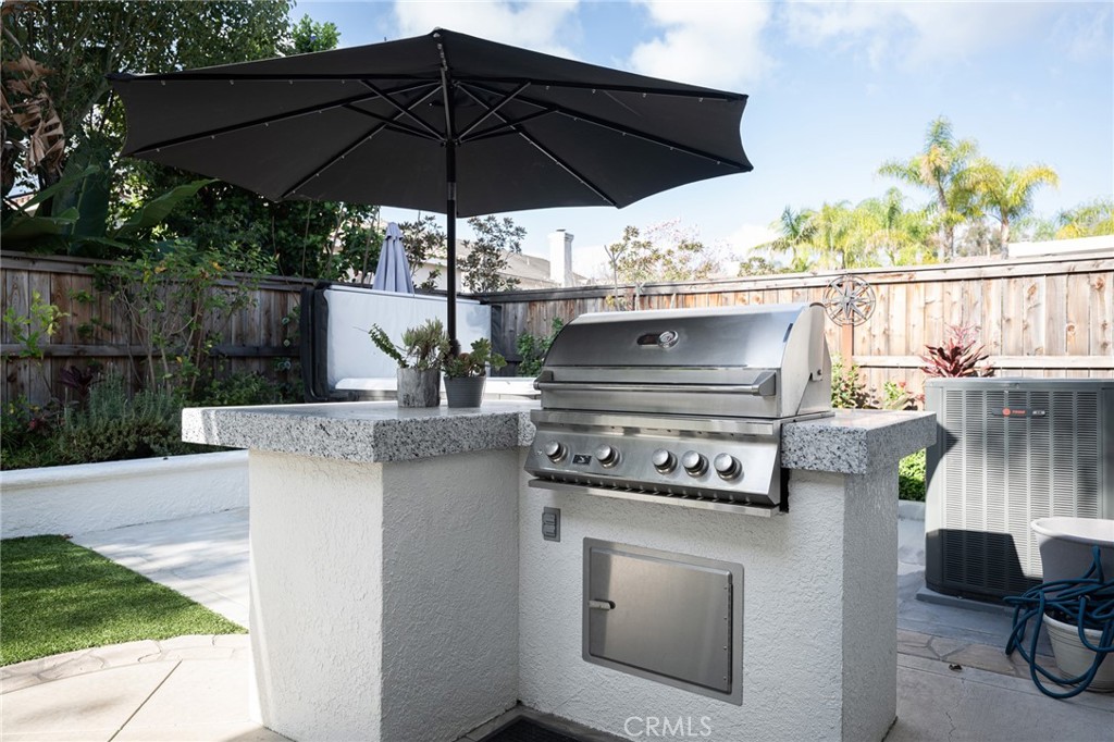 32 Berlamo Rancho Santa Margarita, CA 92688 - Photo 27 of 59 a view of a patio with table and chairs under an umbrella