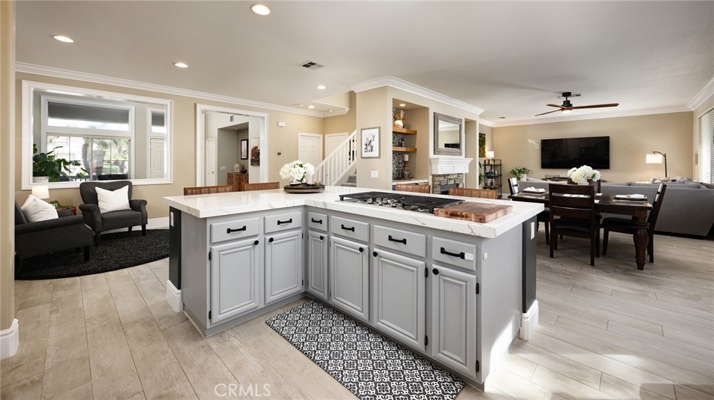 32 Berlamo Rancho Santa Margarita, CA 92688 - Photo 5 of 59 a open kitchen with stainless steel appliances granite countertop a stove top oven a sink dishwasher a dining table and chairs with wooden floor