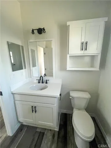 a bathroom with a toilet a sink and mirror