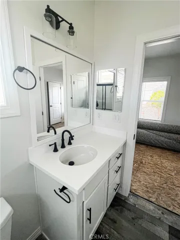 a bathroom with a sink a toilet and a mirror