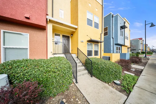 a front view of a multi story residential apartment building with a yard