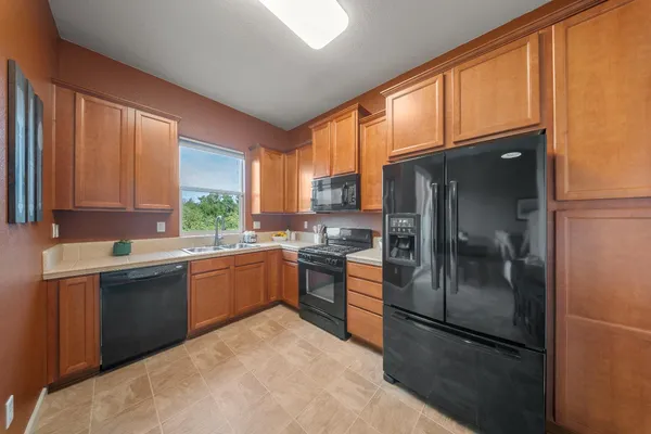 a kitchen with a refrigerator and a sink