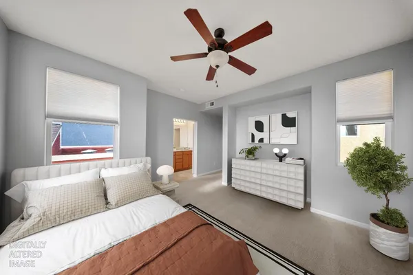 a bedroom with a large bed and paintings on the wall