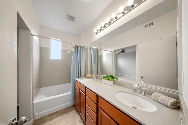 a bathroom with a double vanity sink and a mirror