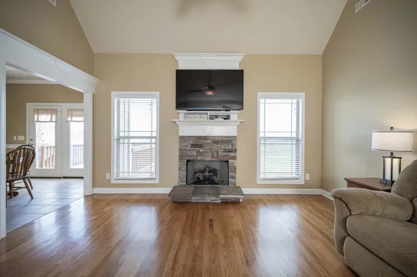 a view of a dining room with furniture and chandelier