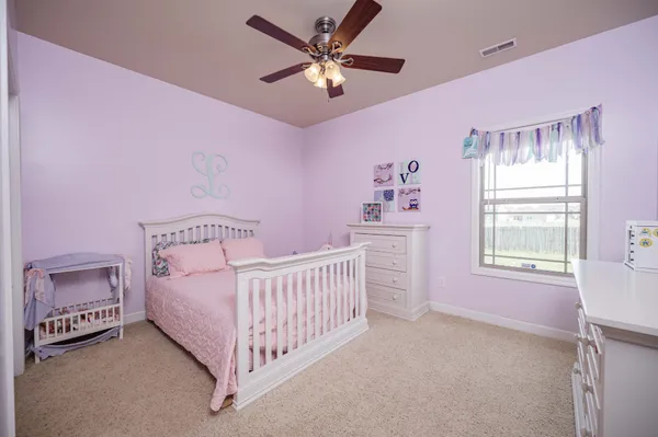 a bedroom with a bed and chandelier