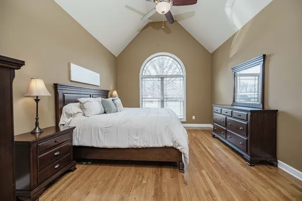 a bedroom with a bed and a chandelier