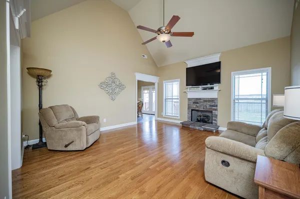 a living room with furniture and a wooden floor