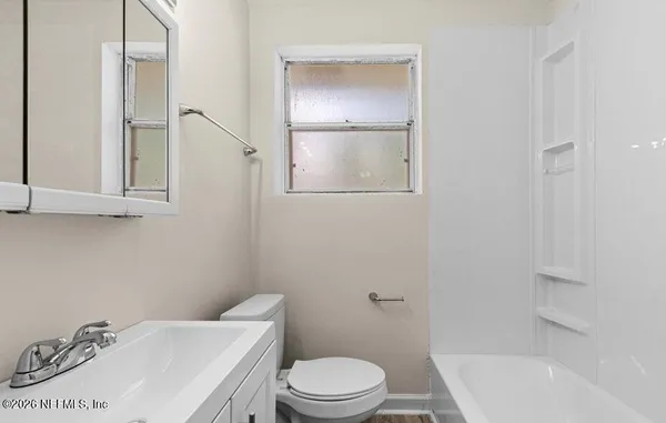 a white toilet sitting next to a bathroom sink