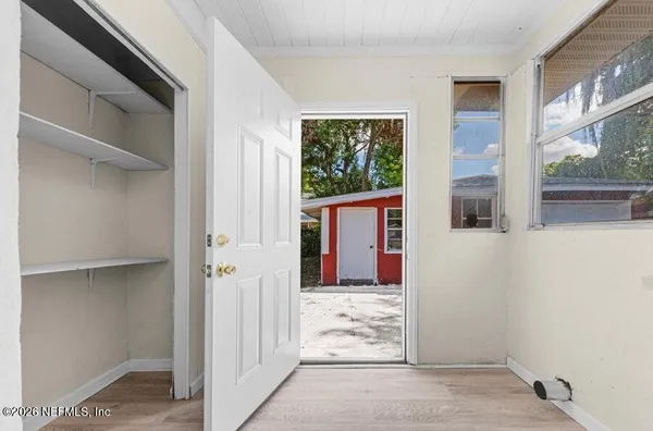 a view of a house with wooden floor and a window