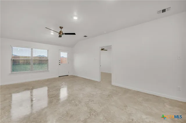 an empty room with a empty space and windows