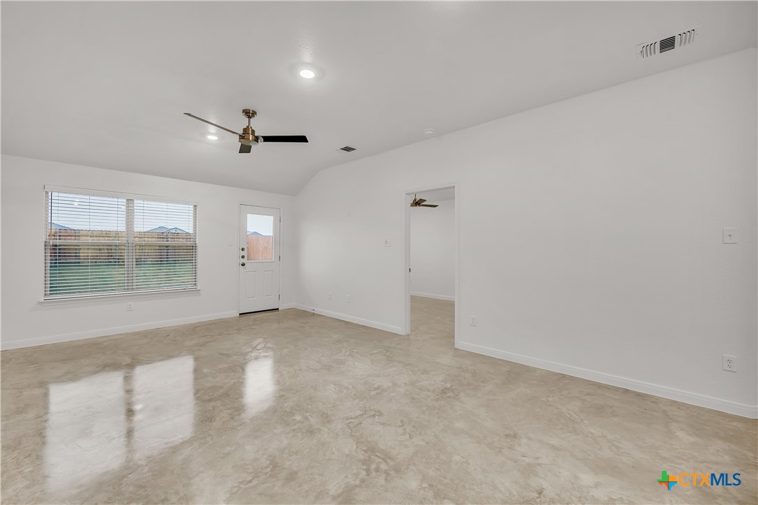 909 Wax Myrtle Court, Unit B Killeen, TX 76543 - Photo 2 of 15 an empty room with a empty space and windows