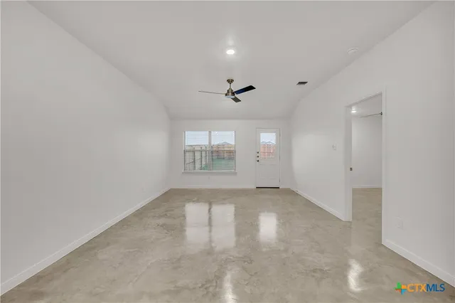 an empty room with a empty space and windows