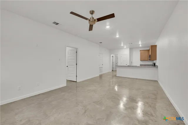 a view of a kitchen with a sink and a refrigerator