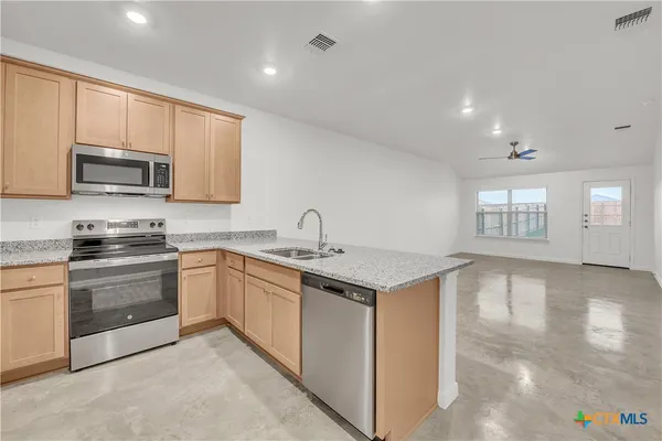 a kitchen with a sink stove and microwave